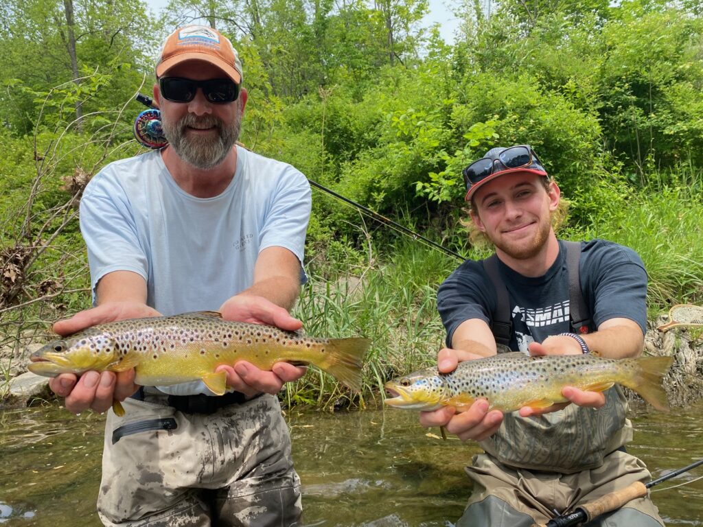 Guided clients holding weild brown trout caught with scott grassi and keystonbe anglers guide service on fkly fishing trip to spring creek in bellefonte pennsylvania
