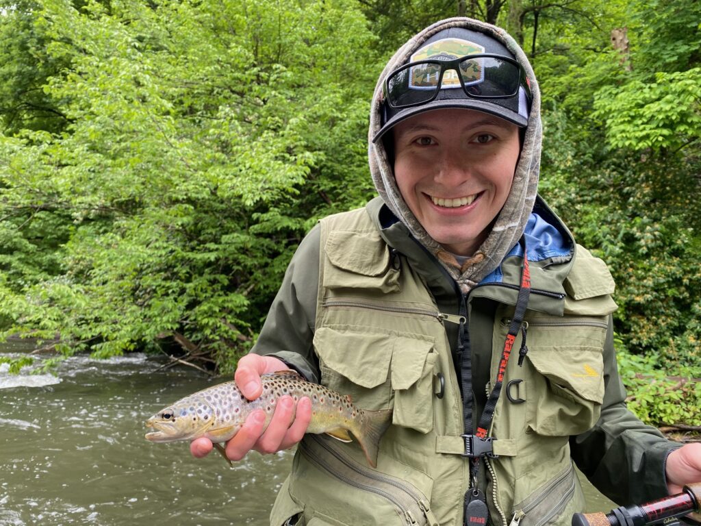 guided client holding a wild brown trout caught with keystone anglers guide service on spring creek in bellefonte pennsylvania