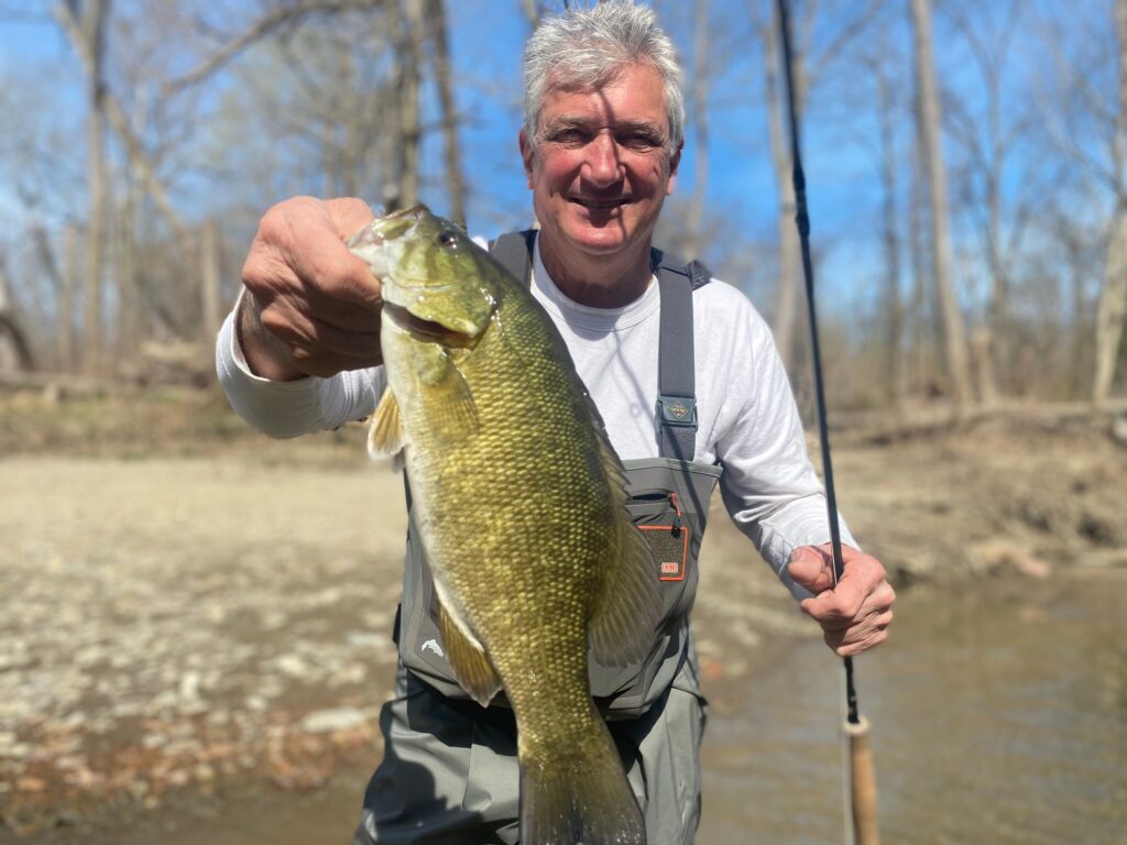 guided client hokding trophy lake erie lake run smallmouth bass he caught on trip with keystone anglers guide service on conneaut creek near conneaut ohio